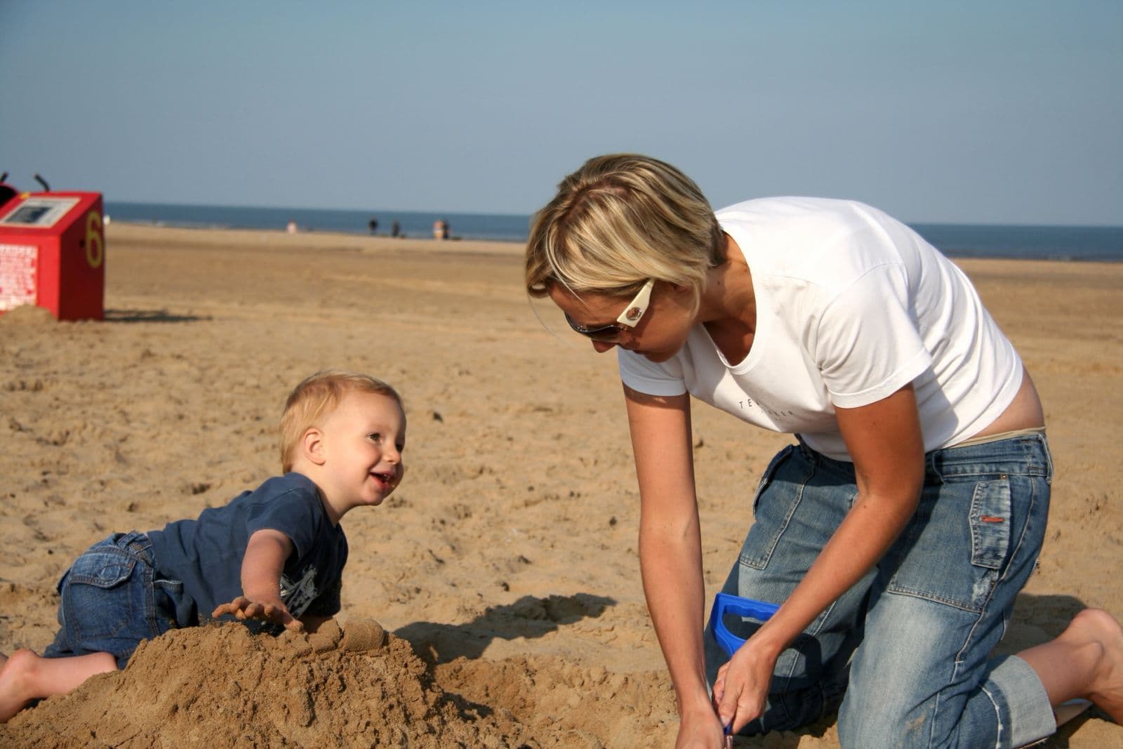 Seb as a toddler building sandcastles on the beach with his mum (1 of 8)