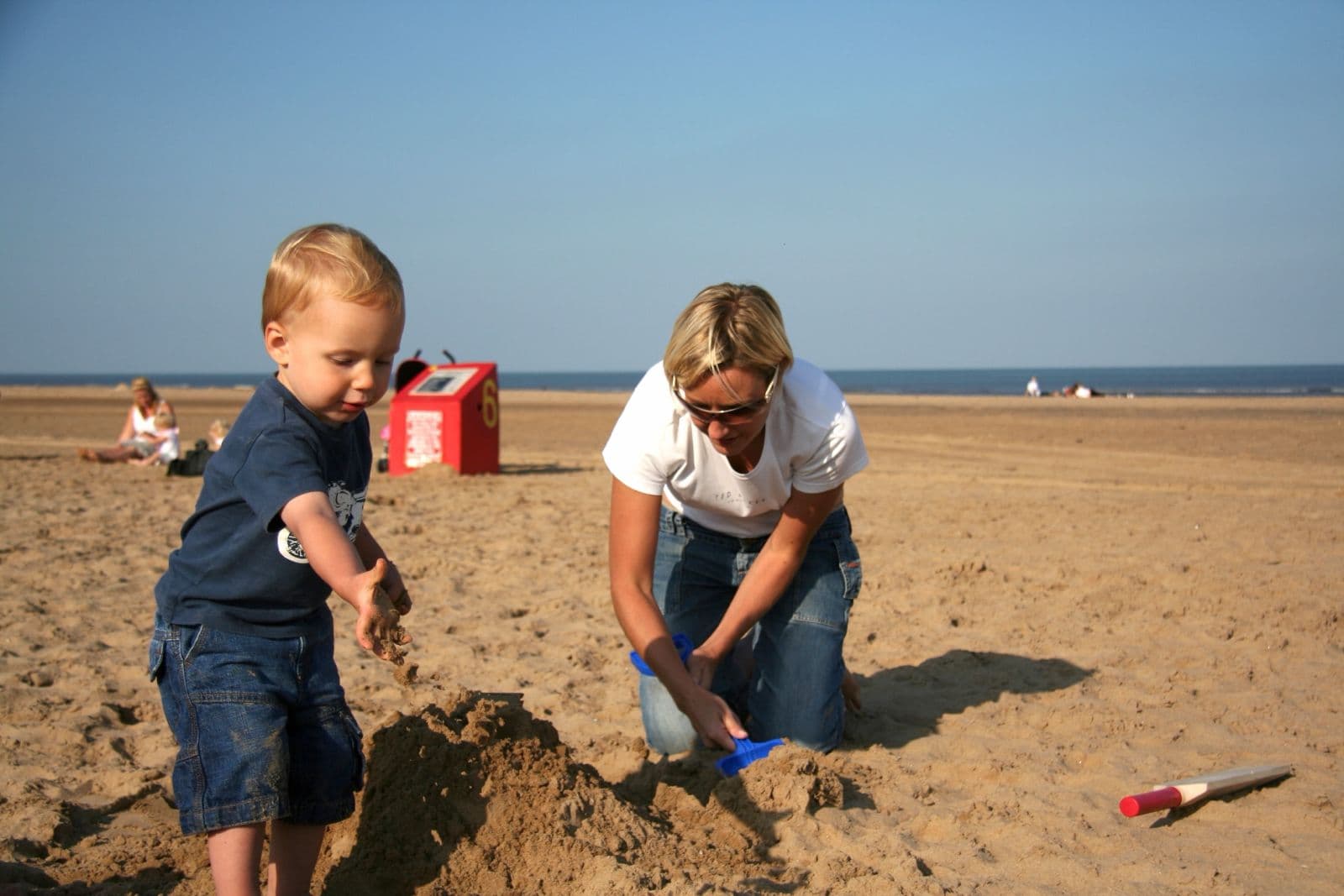 Seb as a toddler building sandcastles on the beach with his mum (2 of 8)