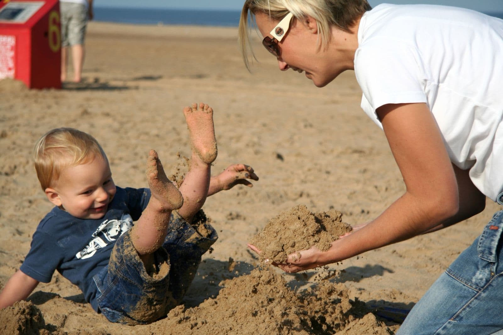 Seb as a toddler building sandcastles on the beach with his mum (3 of 8)