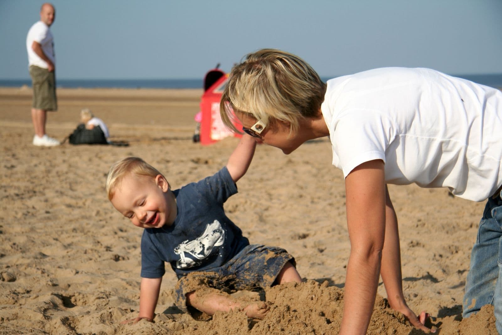 Seb as a toddler building sandcastles on the beach with his mum (4 of 8)