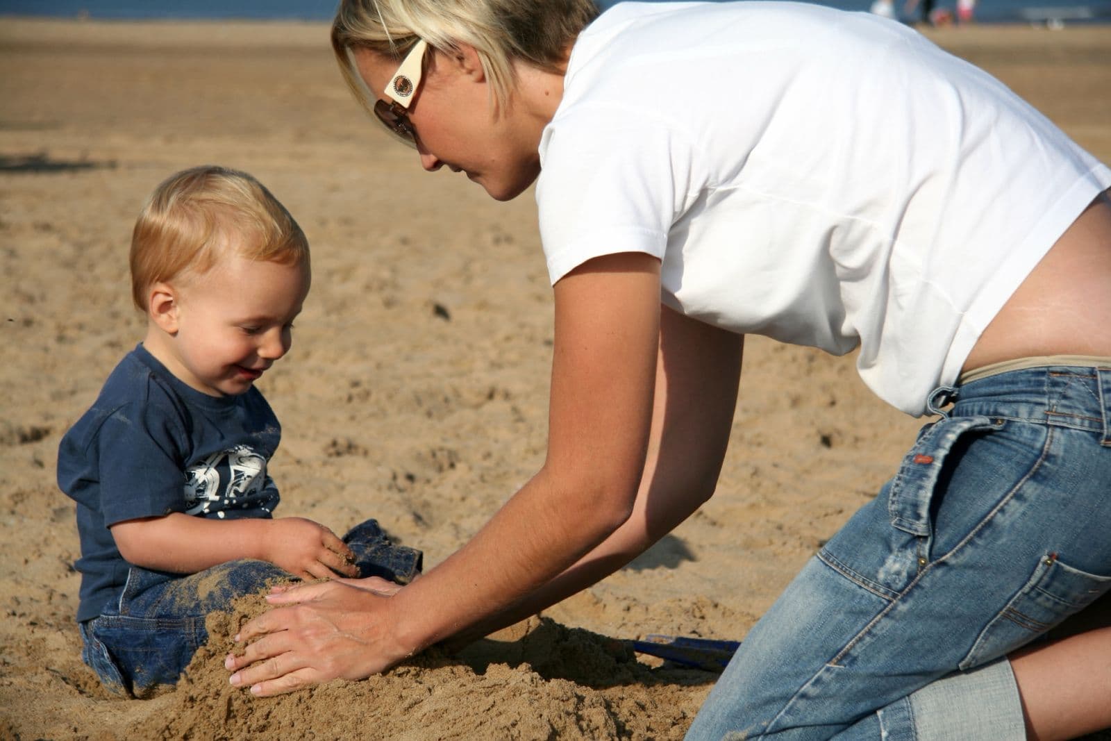 Seb as a toddler building sandcastles on the beach with his mum (5 of 8)