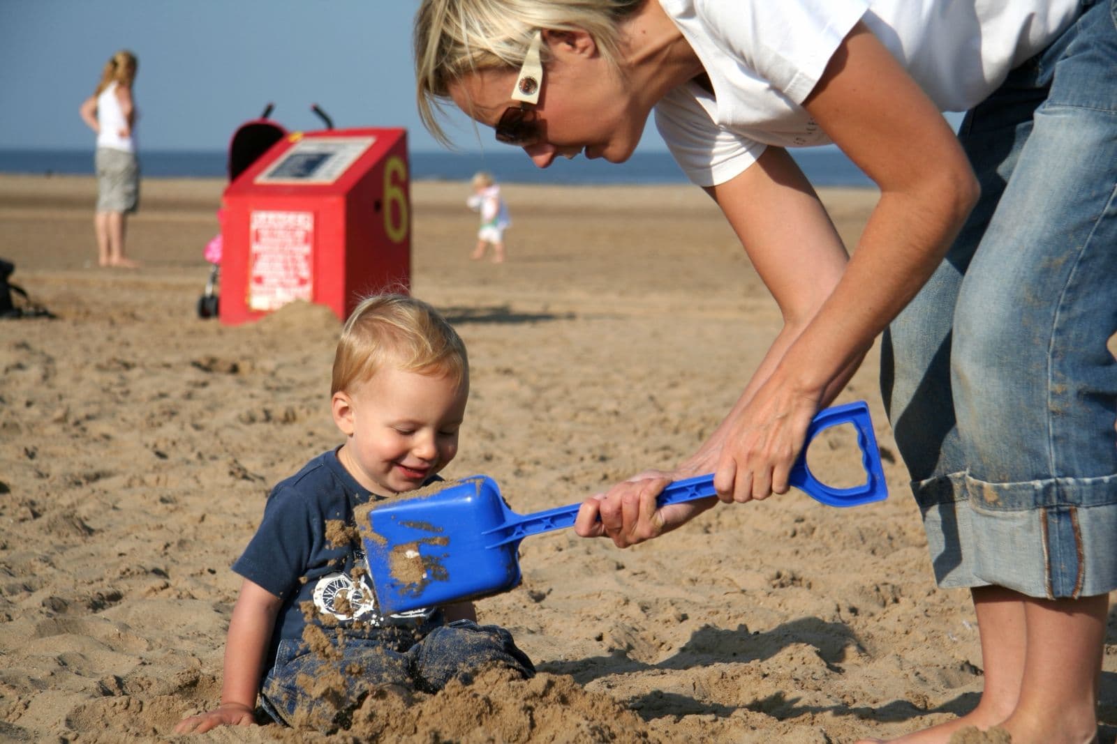 Seb as a toddler building sandcastles on the beach with his mum (6 of 8)
