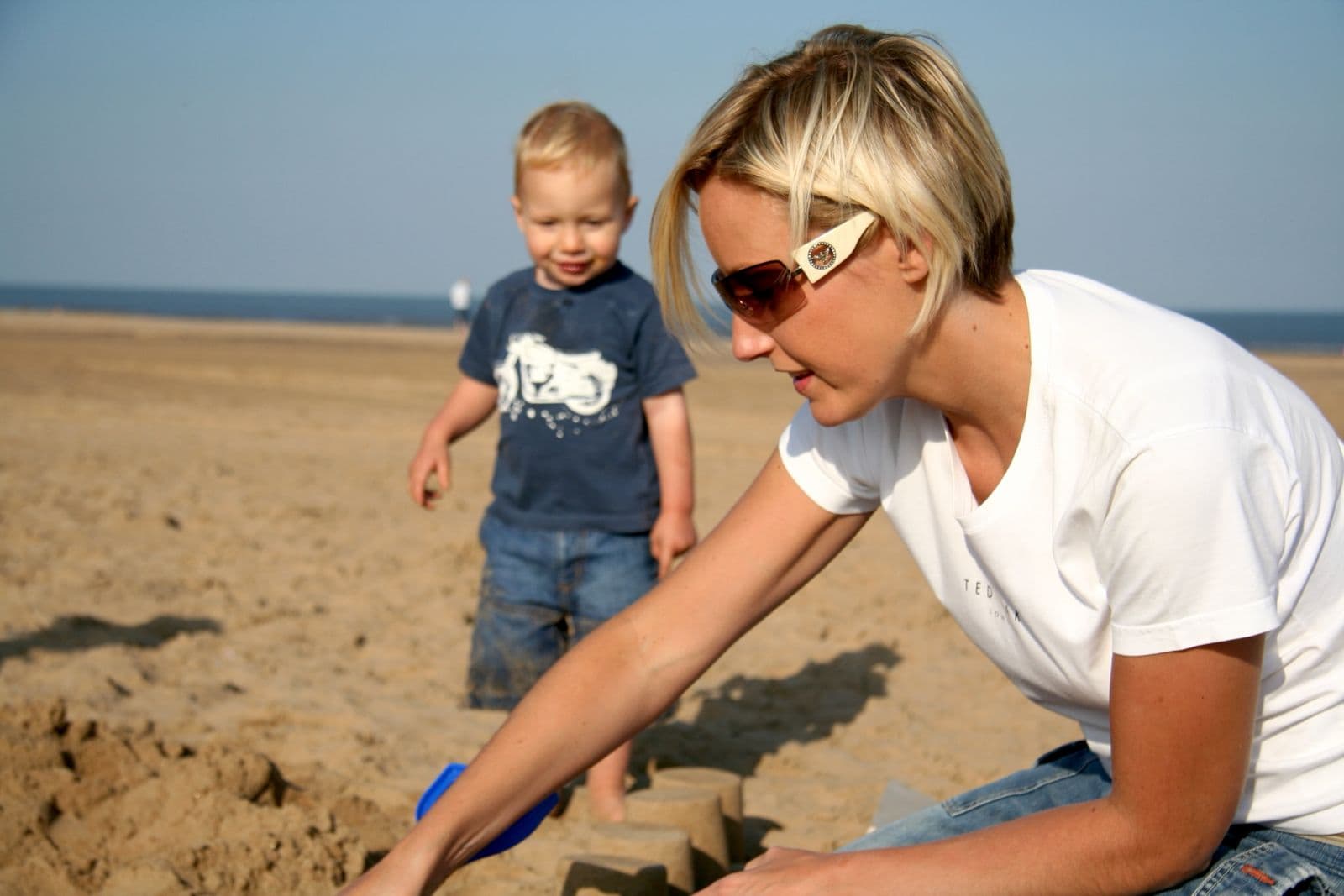 Seb as a toddler building sandcastles on the beach with his mum (7 of 8)