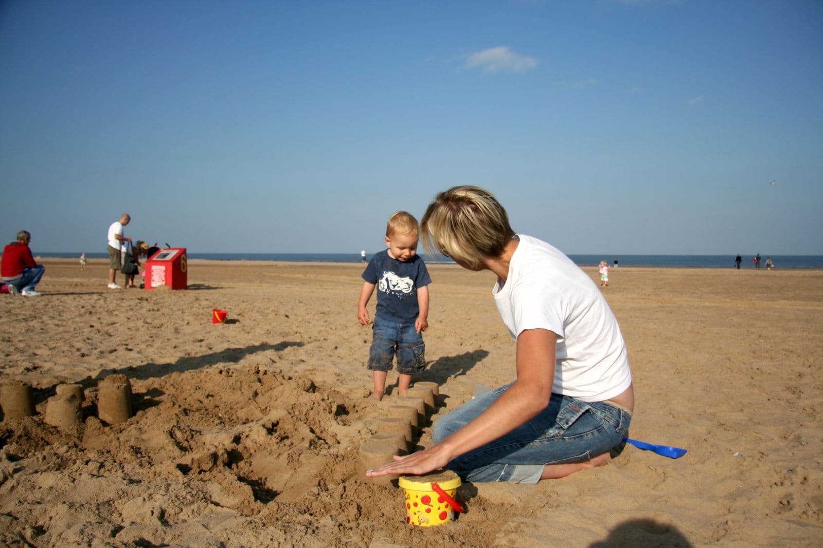 Seb as a toddler building sandcastles on the beach with his mum (8 of 8)